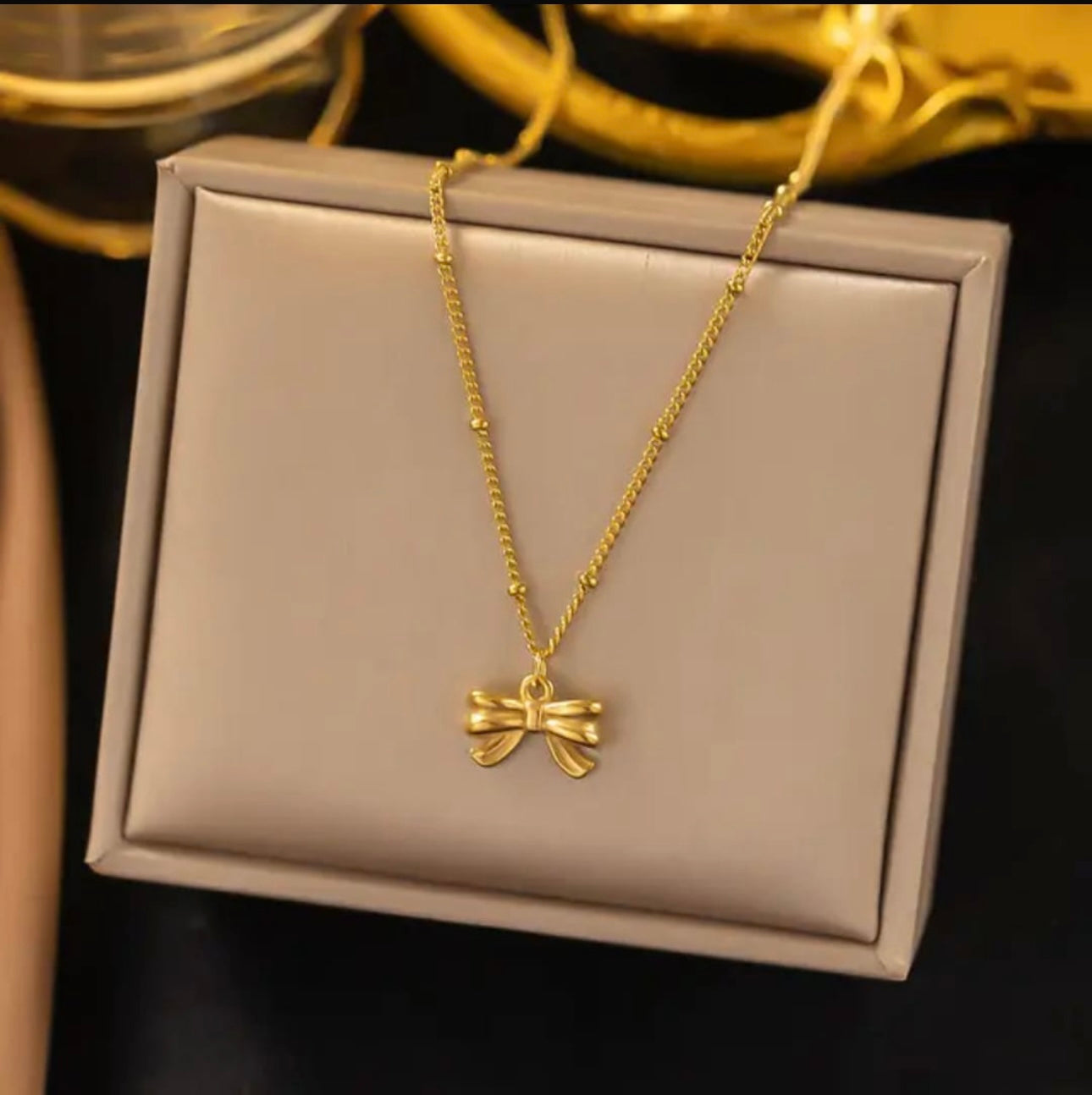 Golden Bow Pendant Necklace – Elegant Charm